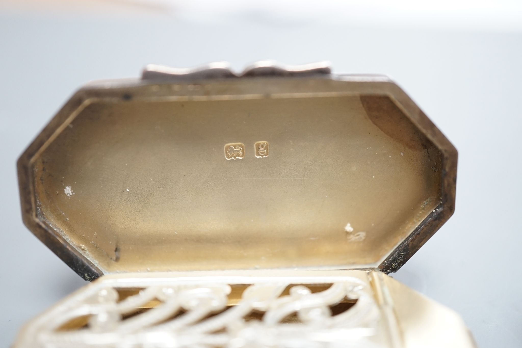 An Edwardian silver octagonal vinaigrette, with engraved sunburst decoration, maker, B.C Birmingham, 1906, 51mm and a smaller earlier vinaigrette by George Unite.